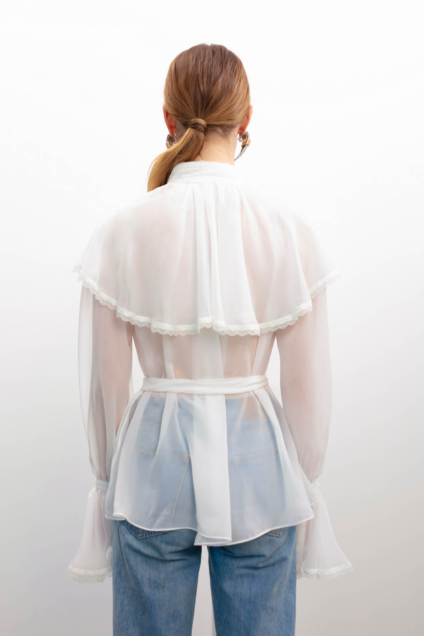 Model in Ocean Of Tenderness white blouse back view