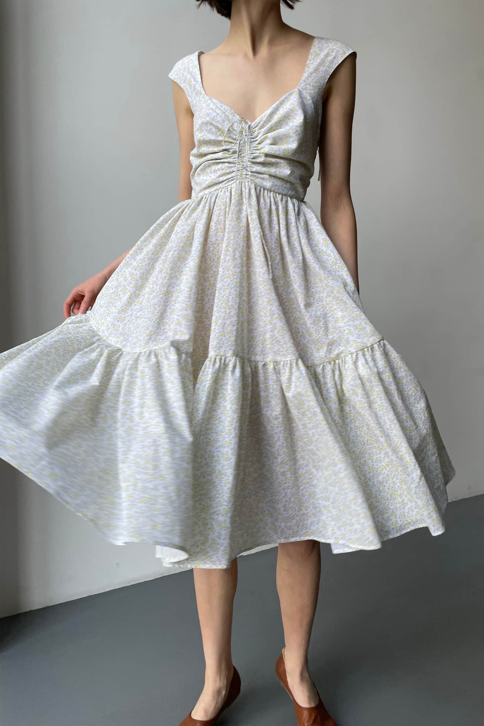 Model in open tie back Song of the Winds midi dress front view
