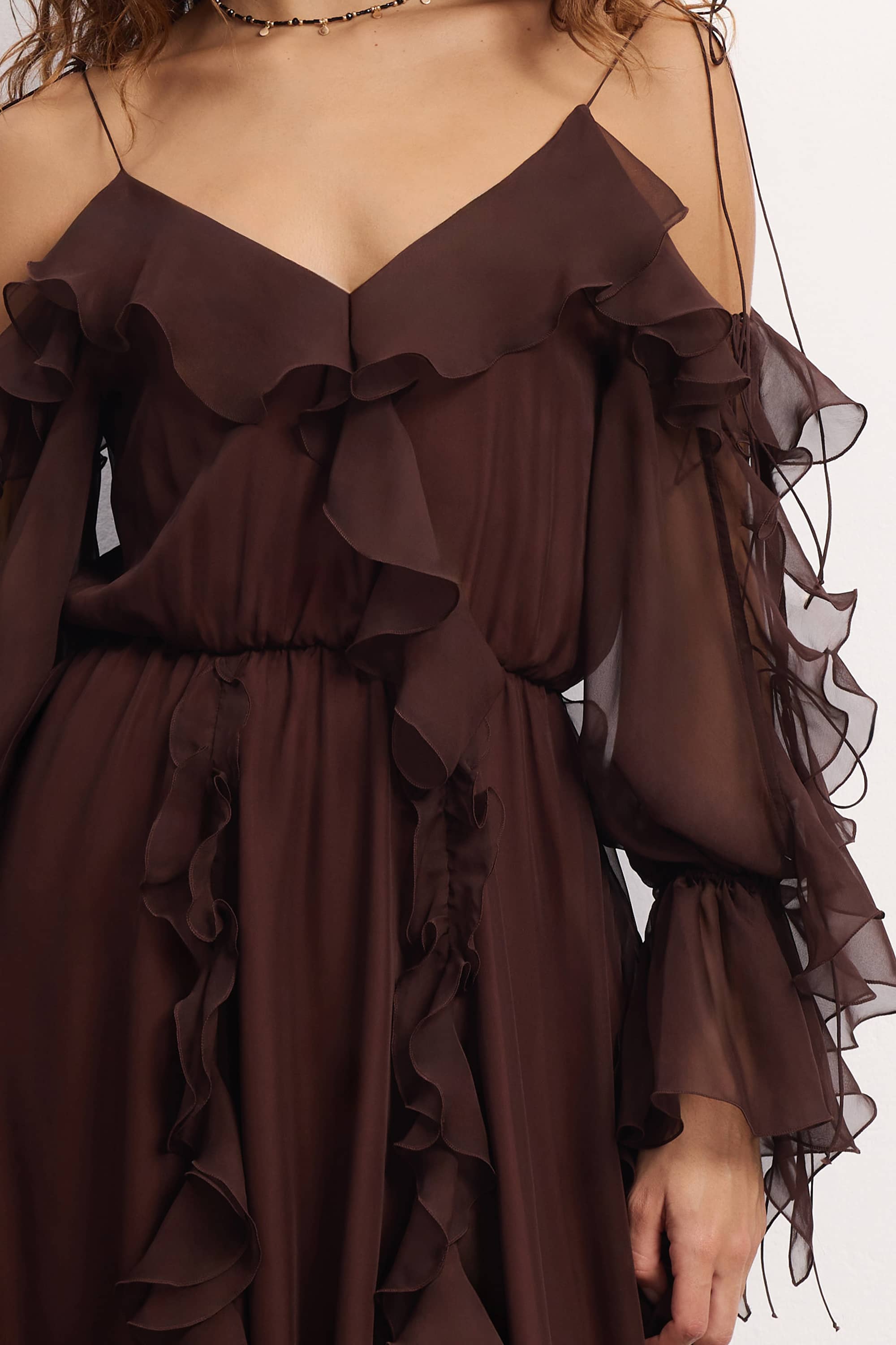 Woman wearing a brown off-shoulder ruffled Morning Forest midi dress on a white background, details front view